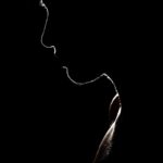 Artistic silhouette of a person against a dark background, evoking mystery and solitude.