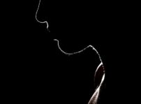 Artistic silhouette of a person against a dark background, evoking mystery and solitude.